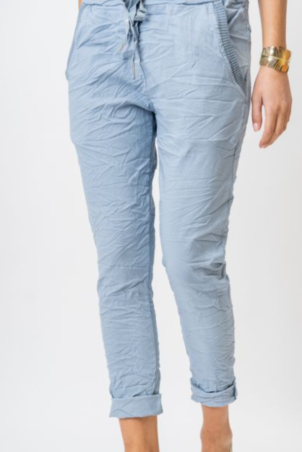 Light blue quilted pants worn by a person on a white background
