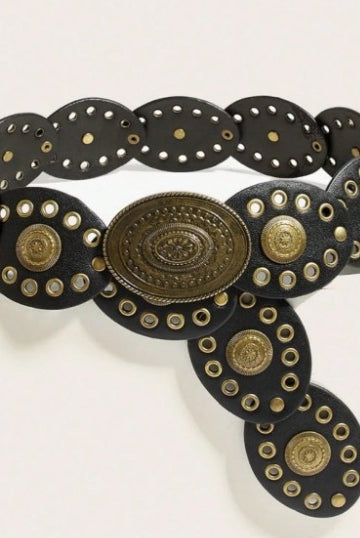 A black leather belt with ornate brass-toned conchos and circular studs, photographed on a plain light background.