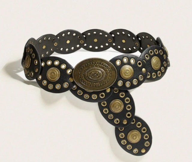 A black leather belt with ornate brass-toned conchos and circular studs, photographed on a plain light background.