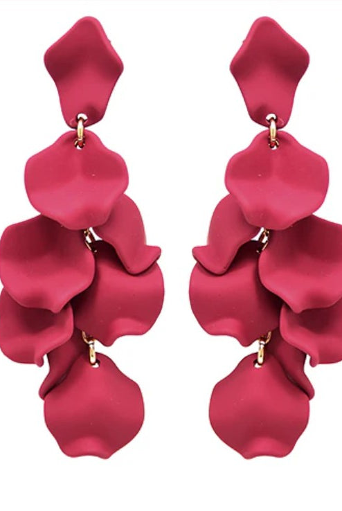 Pair of red petal-shaped earrings on a white background