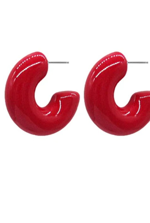 Pair of red hoop earrings on a white background