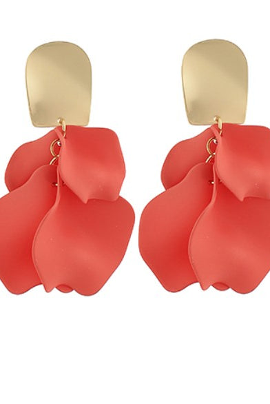 Red petal-shaped earrings with gold hooks on a white background