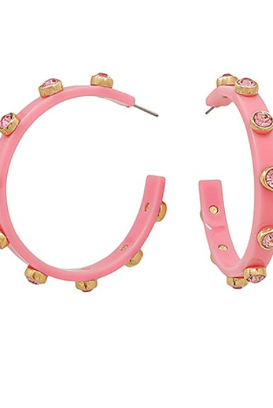 Pink hoop earrings with gold accents on a white background