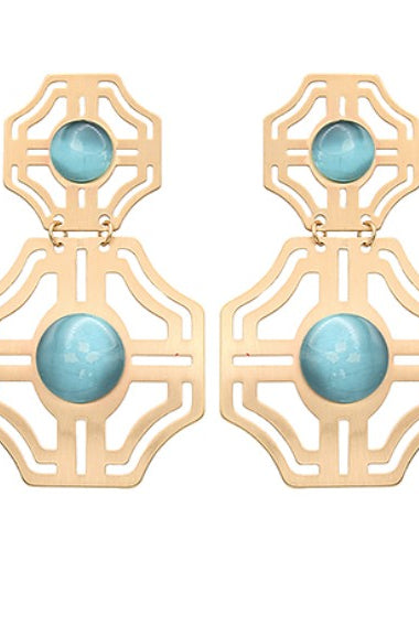Gold earrings with turquoise stones on a white background