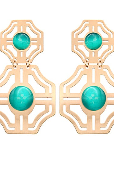 Gold earrings with turquoise stones on a white background