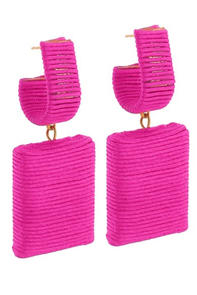 Pair of pink ribbed square earrings on a white background