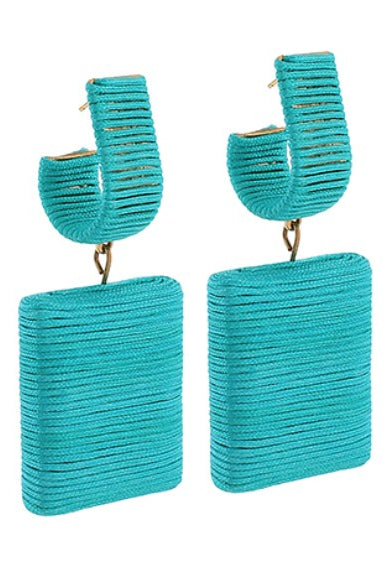 Turquoise earrings with rectangular designs on a white background