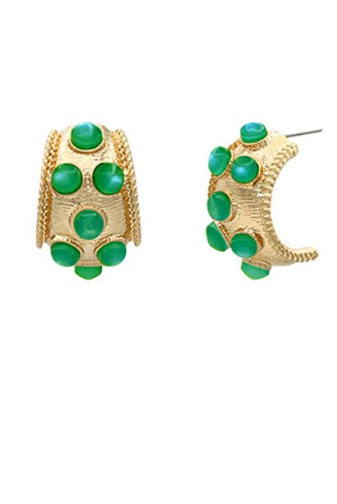 Gold hoop earrings with green gemstones on a white background