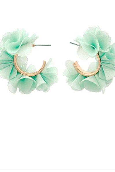 Pair of light green floral hoop earrings on a white background