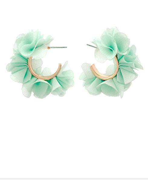 Pair of light green floral hoop earrings on a white background
