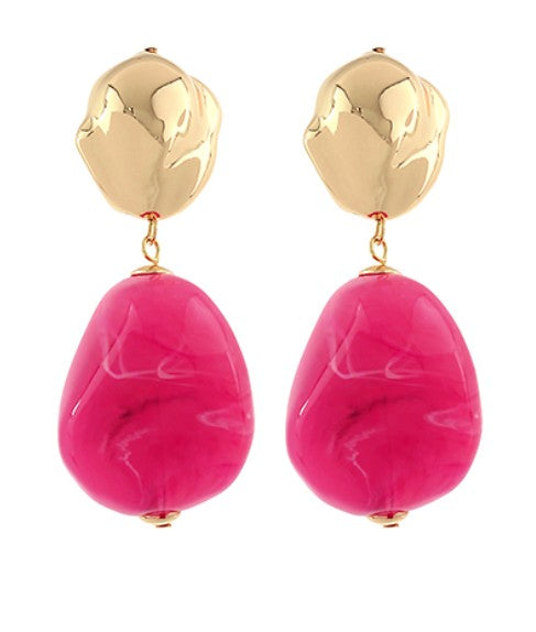 Gold and pink earrings on a white background