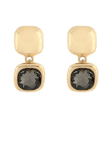 Gold earrings with black gemstones on a white background
