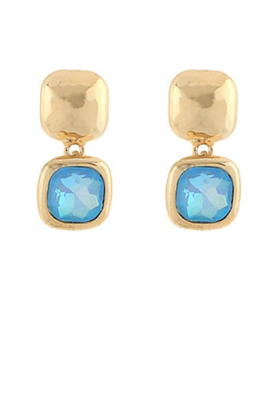 Gold earrings with light blue gemstones on a white background