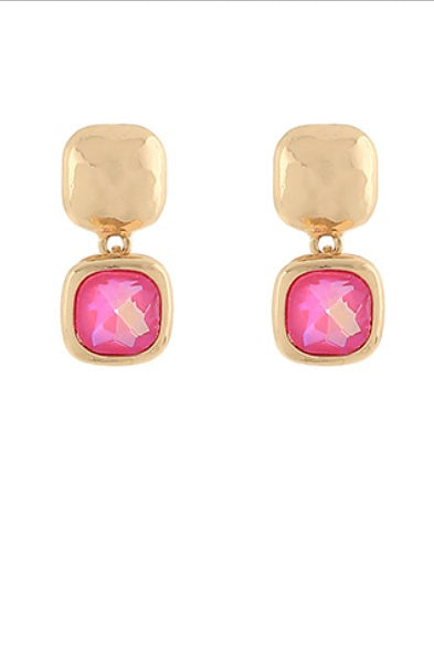 Gold earrings with pink gemstones on a white background