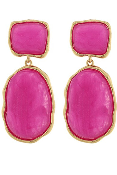 Pink earrings with gold frames on a white background