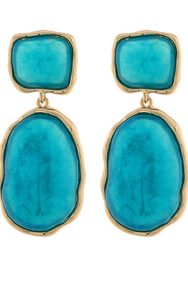 Turquoise stone earrings with gold frames on a white background