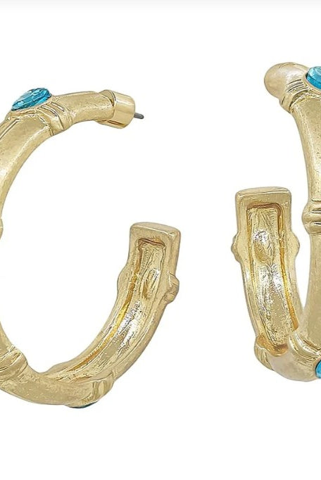 Gold hoop earrings with turquoise stones on a white background