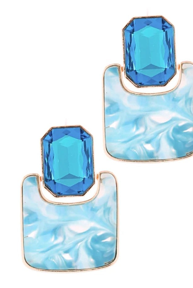 Blue gemstone earrings with marble-like design on a white background