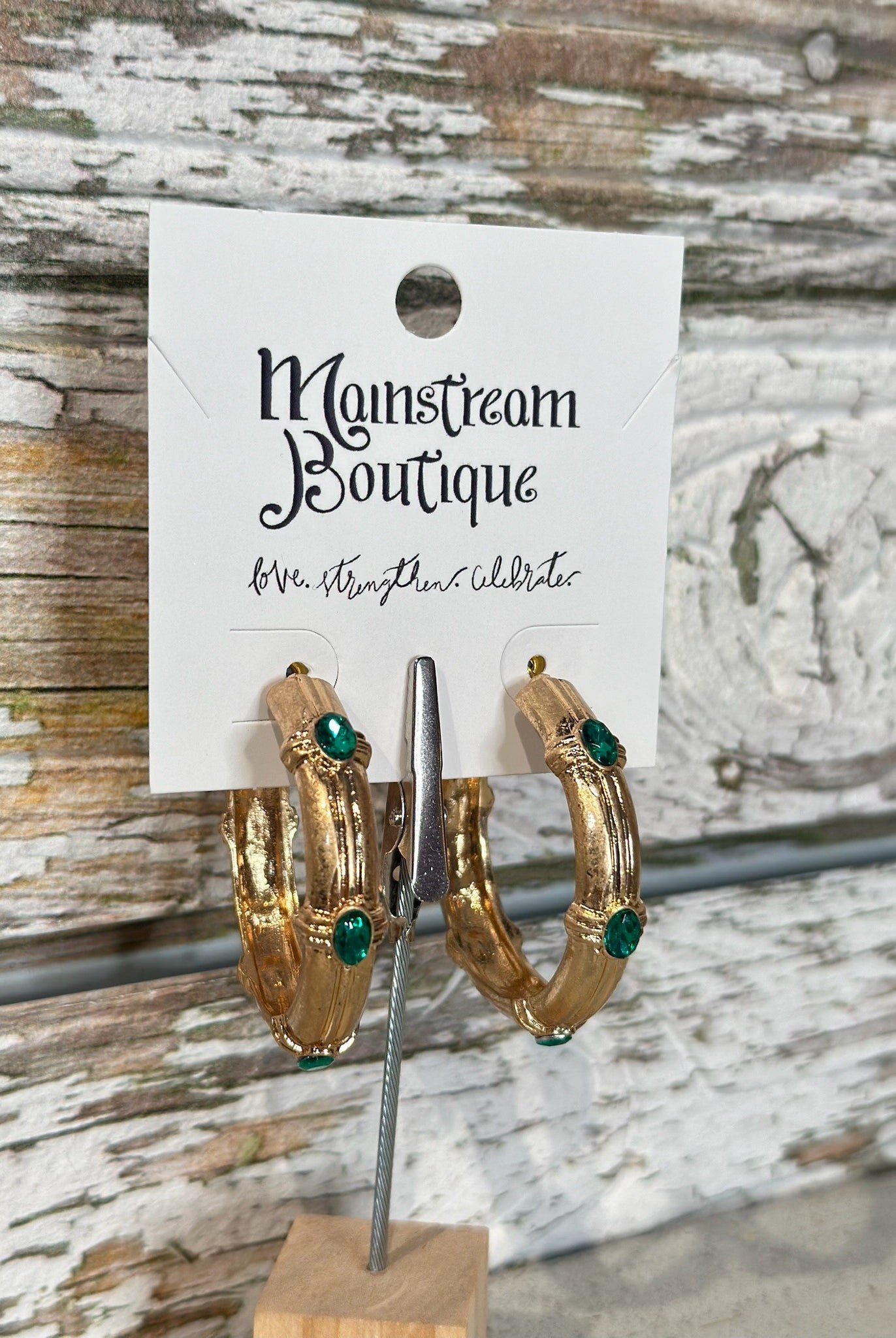 Gold hoop earrings with green gemstones
