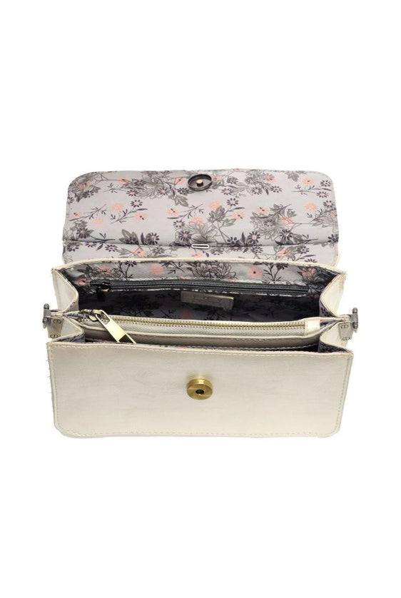Floral-patterned clutch bag with a white exterior on a white background