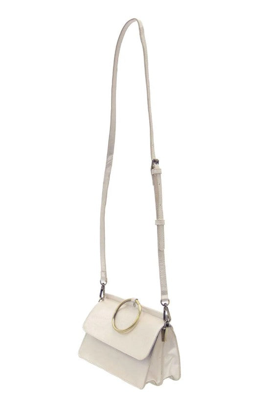 White handbag/crossbody with a gold ring handle on a white background