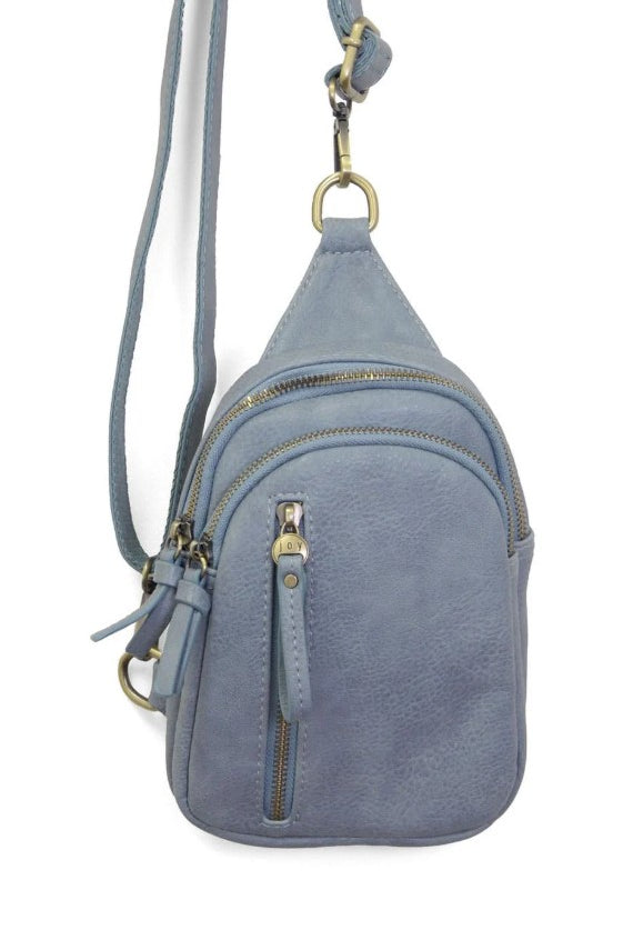 Blue crossbody bag with gold zippers on a white background
