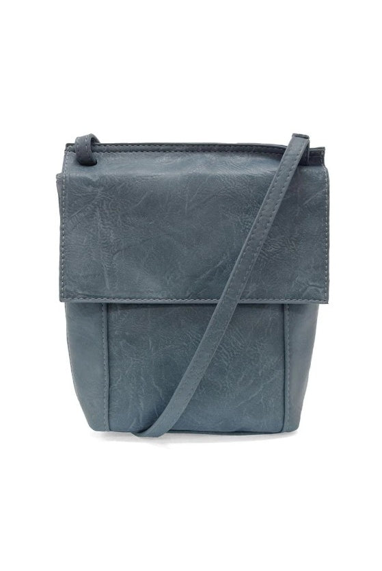 Blue leather crossbody bag on a white background