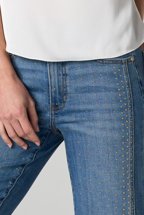 Close-up of blue jeans with gold studs