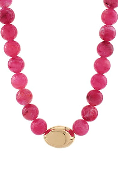 Necklace with pink beads and a gold clasp on a white background