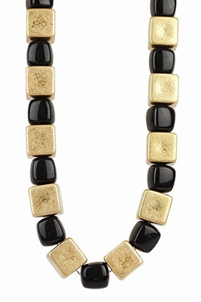 Necklace with gold and black square beads on a white background