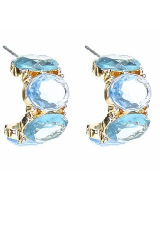 Pair of earrings with blue gemstones and gold accents on a white background
