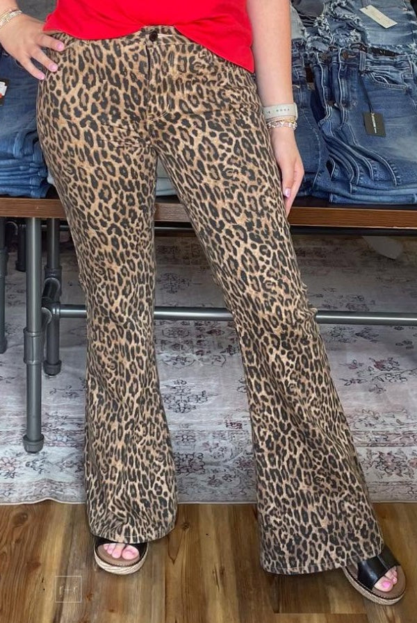 Person wearing leopard print pants in a store setting