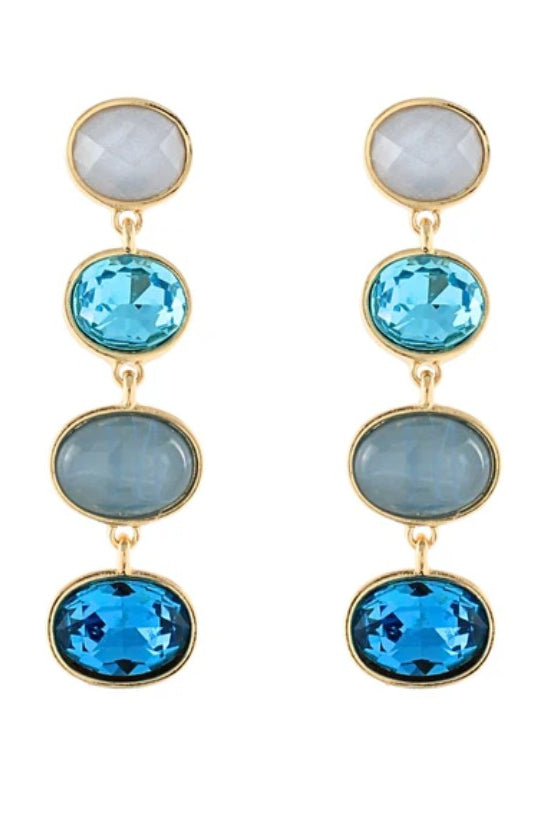 Gold earrings with blue and gray gemstones on a white background