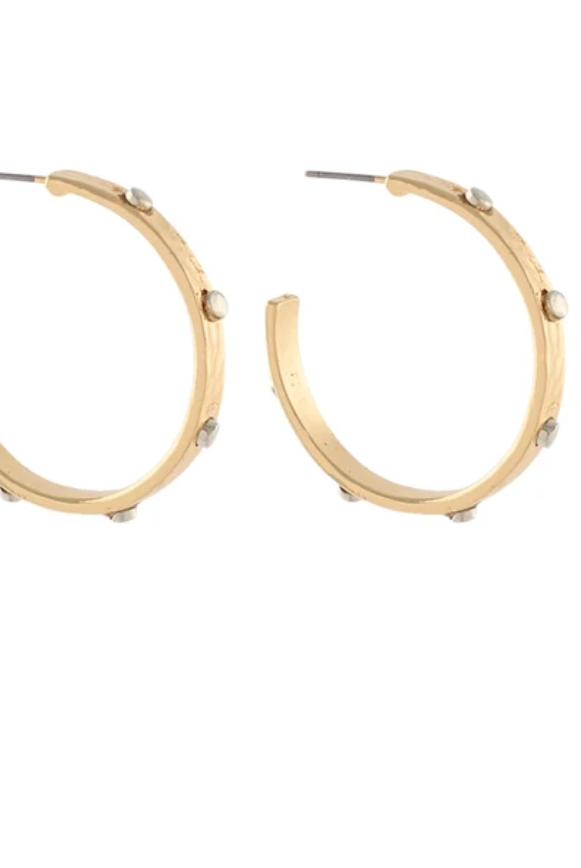 A pair of gold hoop earrings with small silver-toned studs, shown against a plain white background.
