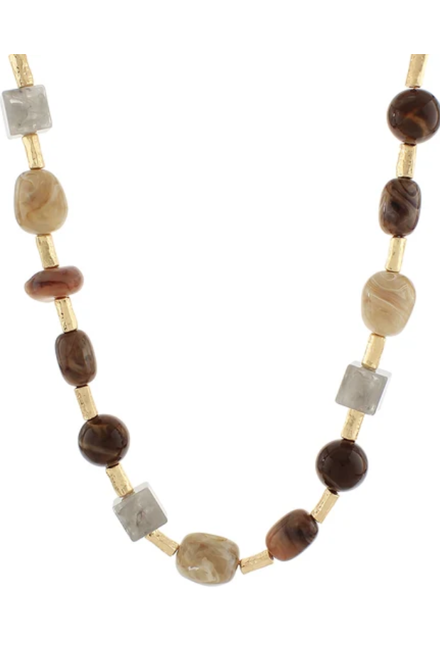 A beaded necklace featuring brown and beige agate-like beads, translucent gray crystal beads, and small gold spacer rings, displayed on a clean white background.