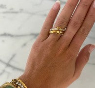 Chansutt Pearls gold ring on a hand with a marble background