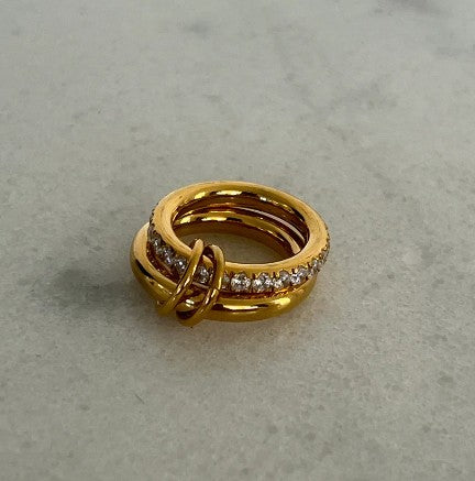 Chansutt Pearls gold ring with embedded stones on a gray surface