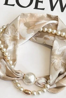 Necklace with pearls and a floral-patterned scarf