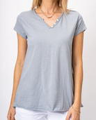 Woman wearing a light gray t-shirt on a white background