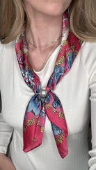 Silky fuchsia floral pearl magnetic scarf featuring vibrant pink and blue botanical prints with an elegant pearl clasp detail.