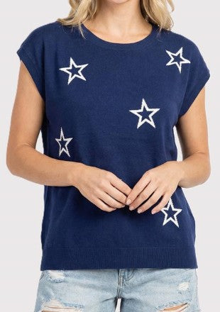 Navy blue top with white star patterns worn by a person 