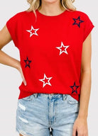 Red t-shirt with star patterns worn by a person 