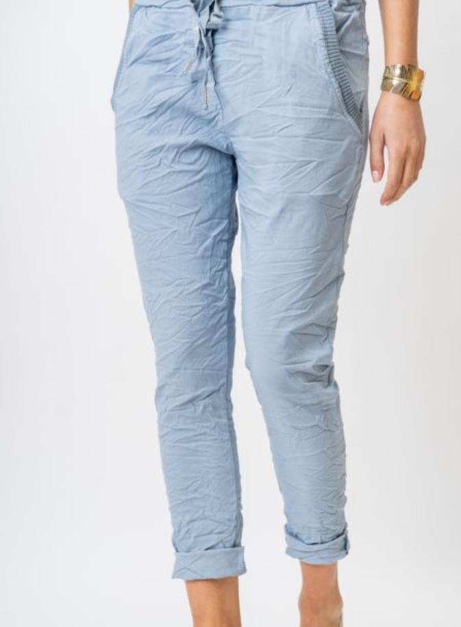 Light blue quilted pants worn by a person on a white background
