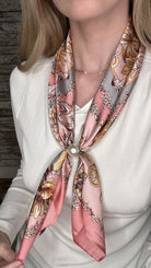 Silky blush pink pearl magnetic scarf featuring a vintage floral print with warm neutral accents and elegant pearl clasp detail.