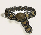 A black leather belt with ornate brass-toned conchos and circular studs, photographed on a plain light background.