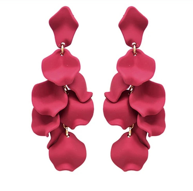 Pair of red petal-shaped earrings on a white background