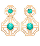 Gold earrings with turquoise stones on a white background