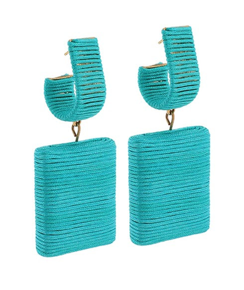 Turquoise earrings with rectangular designs on a white background