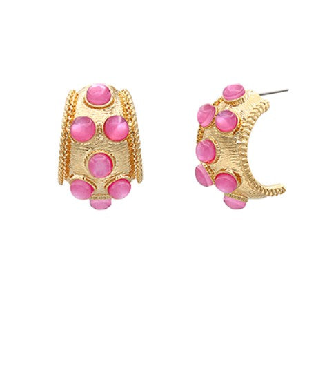 Gold hoop earrings with pink gemstones on a white background