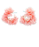Pair of peach floral hoop earrings on a white background